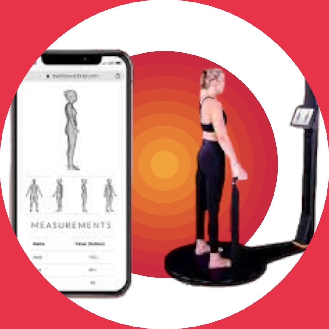 Woman standing on a body scanner platform with a smartphone displaying measurement details beside her.